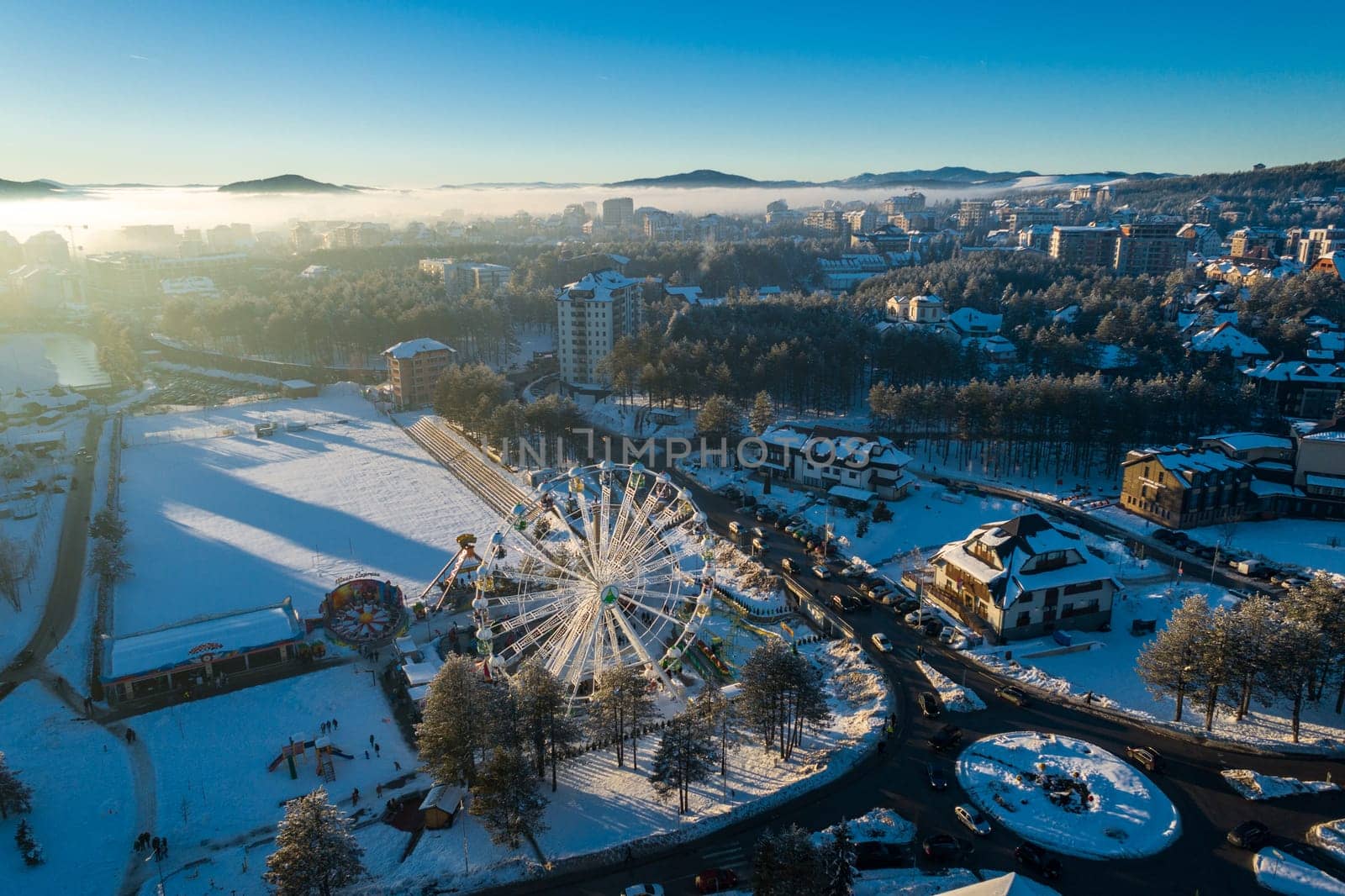 Panoramic aerial view of Zlatibor amusement park and low cloud over Zlatibor Mountain at winter sunset, Cajetina, Serbia.