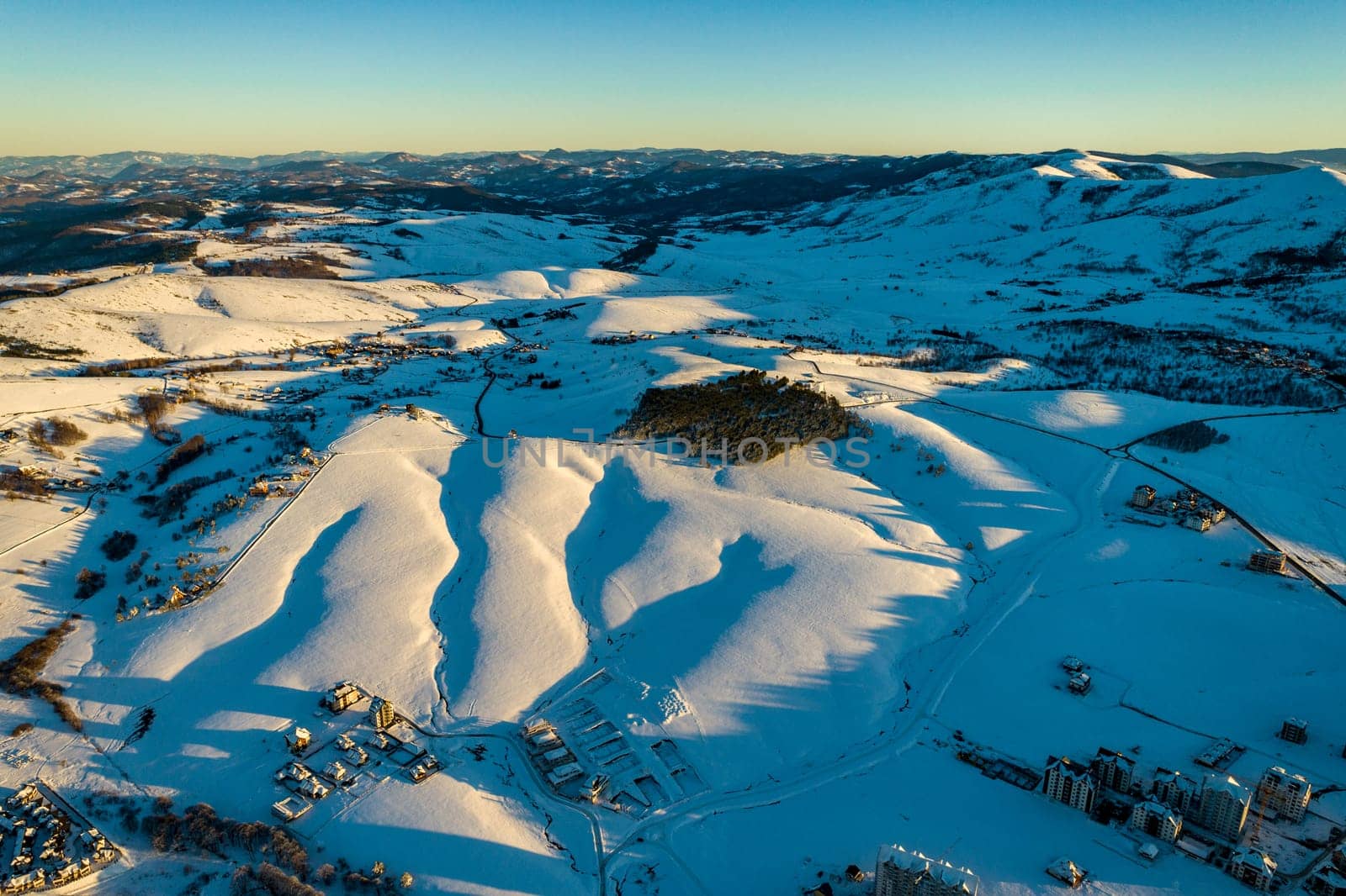 Panoramic aerial view of Zlatibor town and clear sky over Zlatibor Mountain at winter sunset, Cajetina, Serbia.