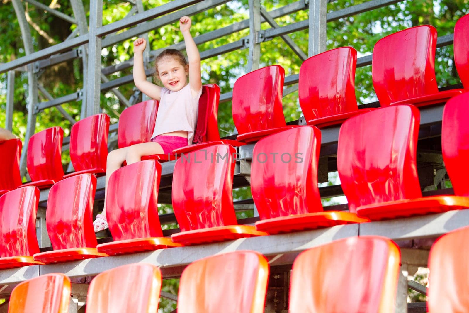 girl in the stands cheering for athletes, spring season