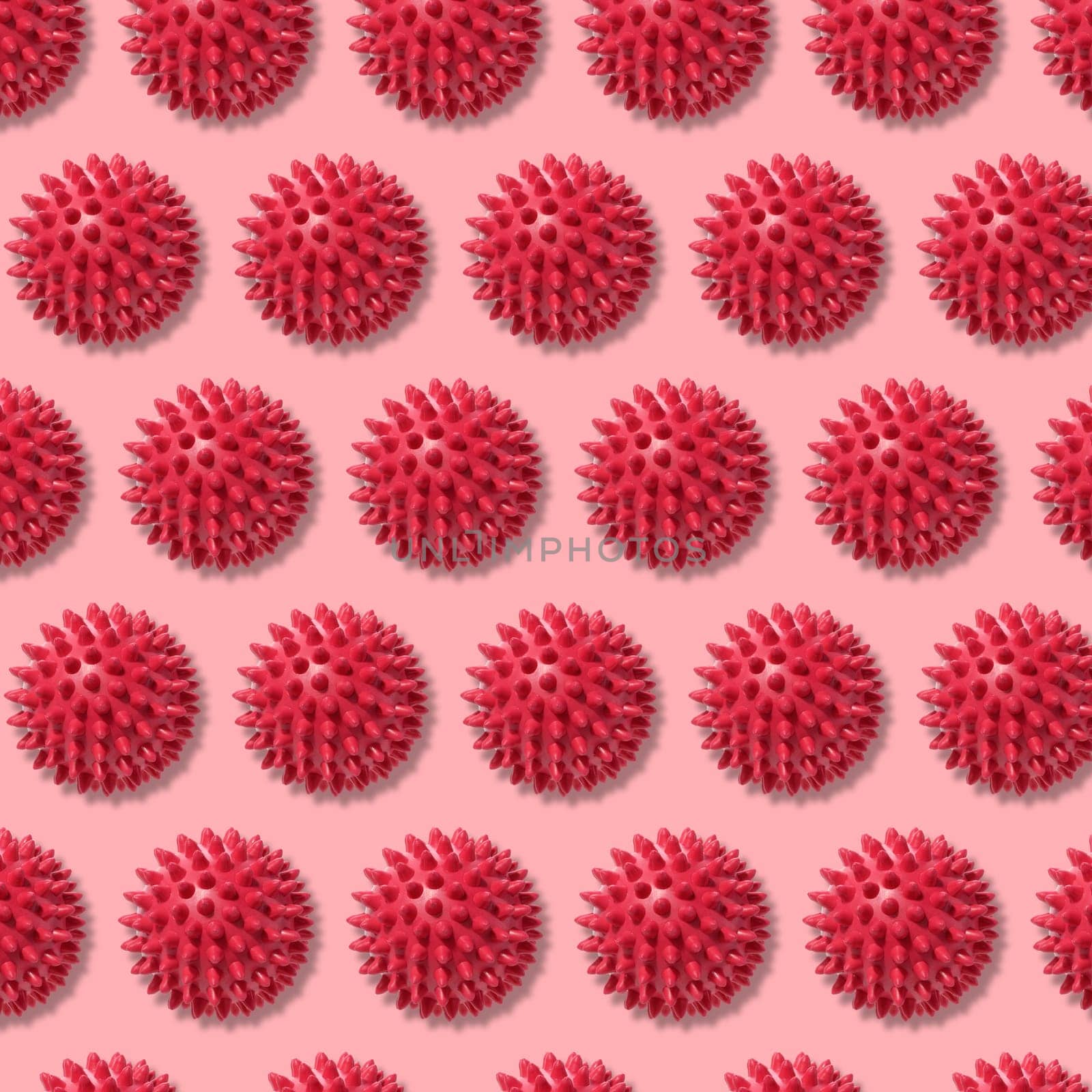 Round red ball with spikes, animal toy or massager. Repeating pattern