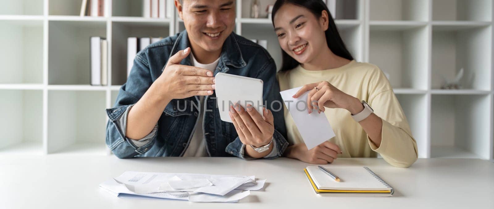 Finance in family concept, Happy Asian couple calculate income and bill to plan for invest or plan income and expenses.