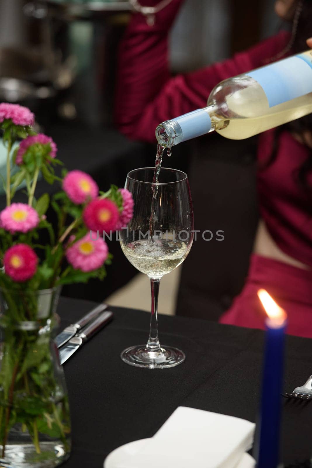 white wine is poured into a glass in a restaurant by Ashtray25