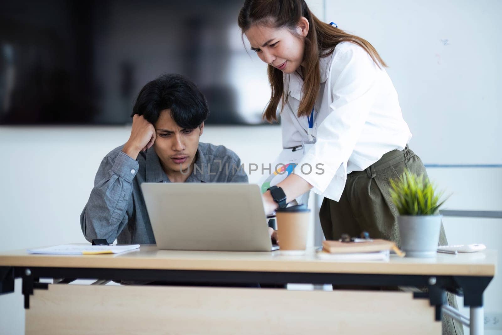 Asian young businesspeople are stress while working in meeting room, Tired businessman with headache at office, feeling sick at work.