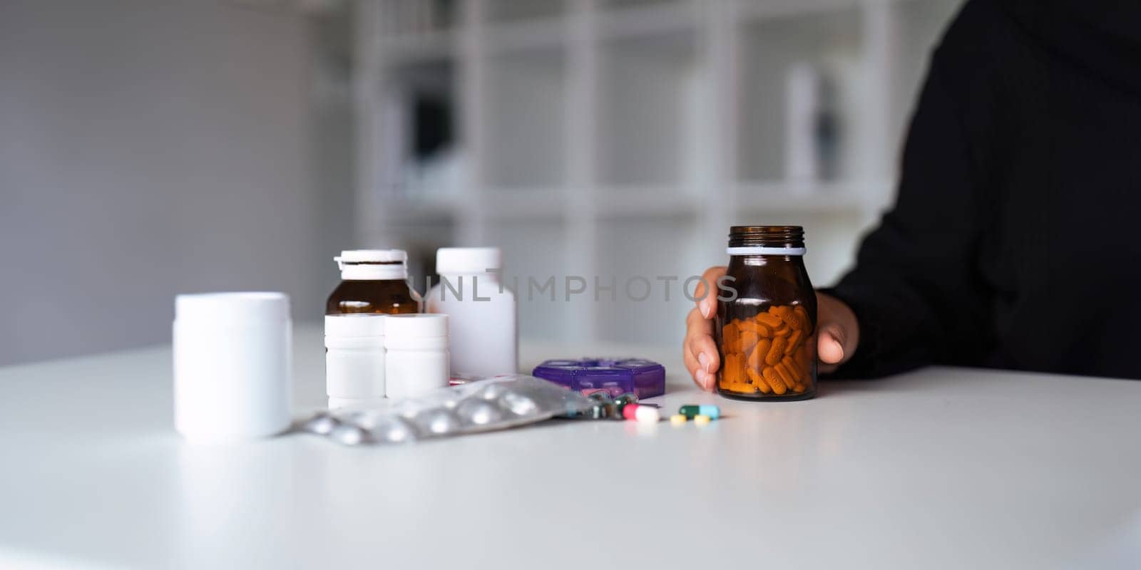 Close up woman holding pill in hand with water feeling sick. female going to take painkiller from headache, painkiller, healthcare, medicine, treatment, therapy, patient, disease illness concept by nateemee