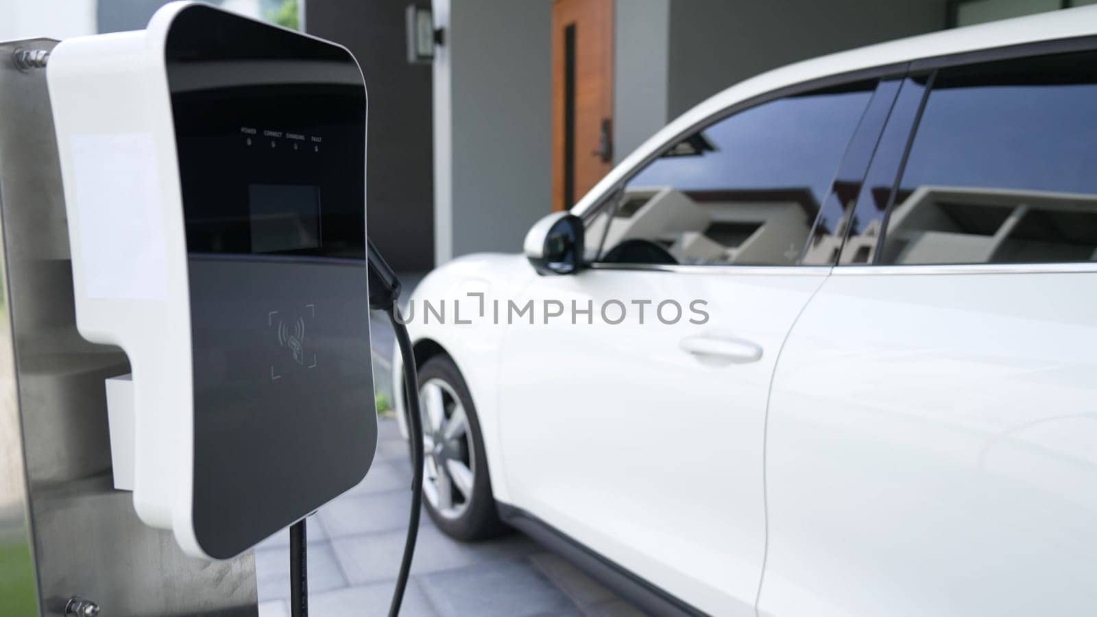 Home charging station provides an eco-friendly sustainable power supply for EV cars. Progressive concept for future green energy storage for electric vehicles.