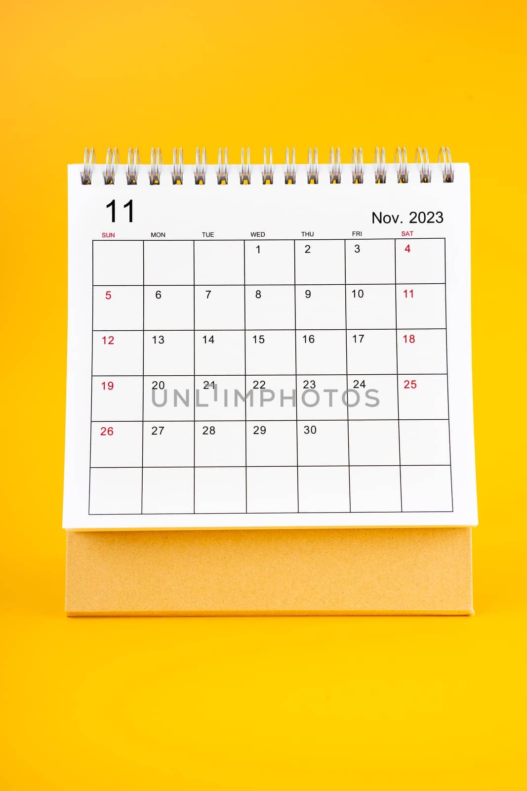 November 2023, Monthly desk calendar for 2023 year on yellow color background.