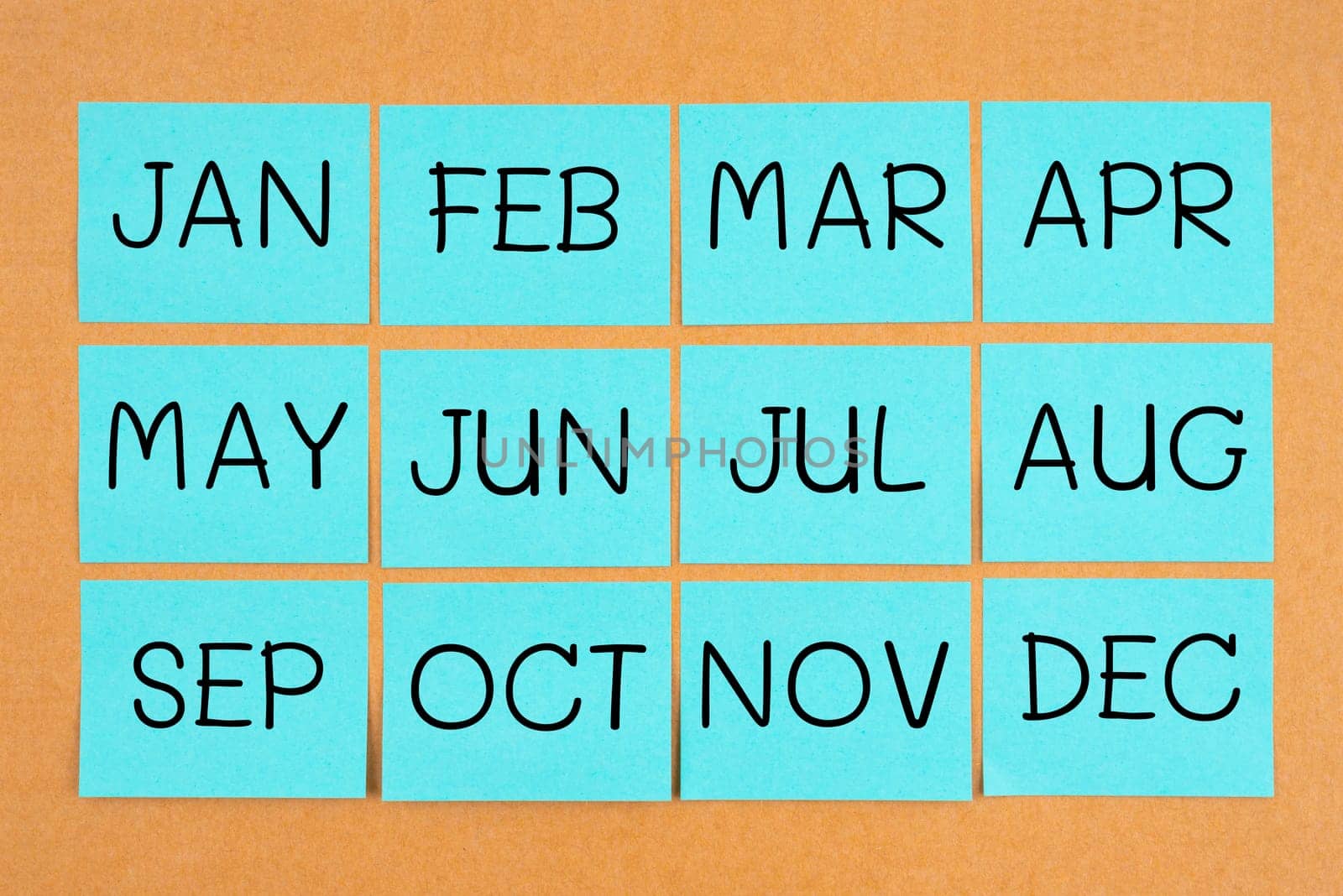 12 months acronyms on blue sticky notes calendar.  by Gamjai