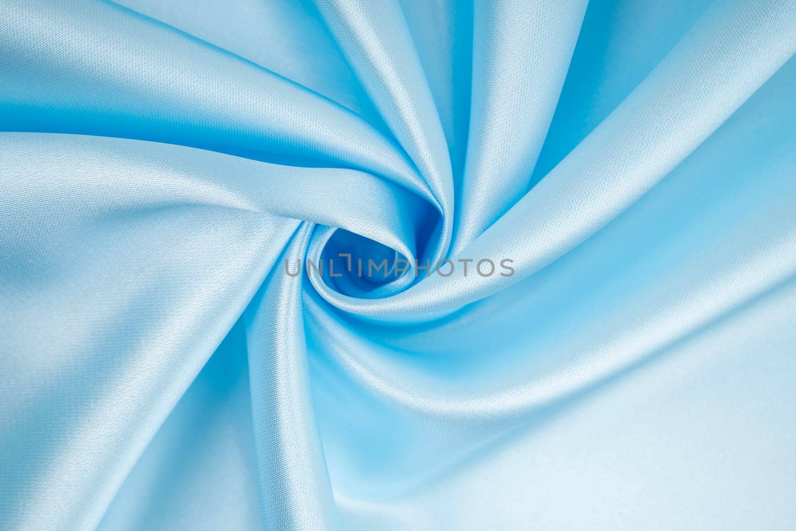The Soft folds and highlights of light blue silk. Whole background. by Gamjai