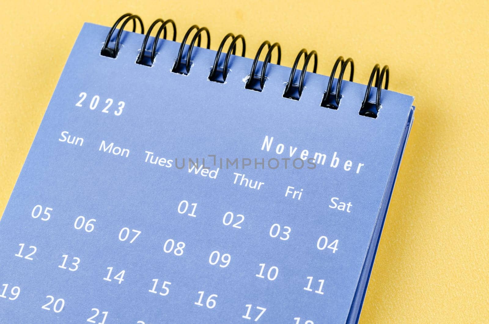 The November 2023 Monthly desk calendar for 2023 year on yellow background. by Gamjai