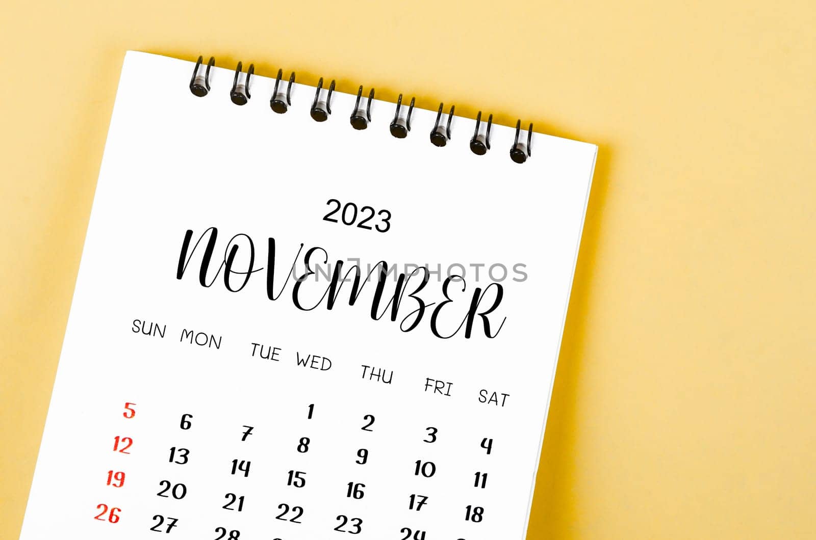 November 2023 Monthly desk calendar for 2023 year on yellow background.