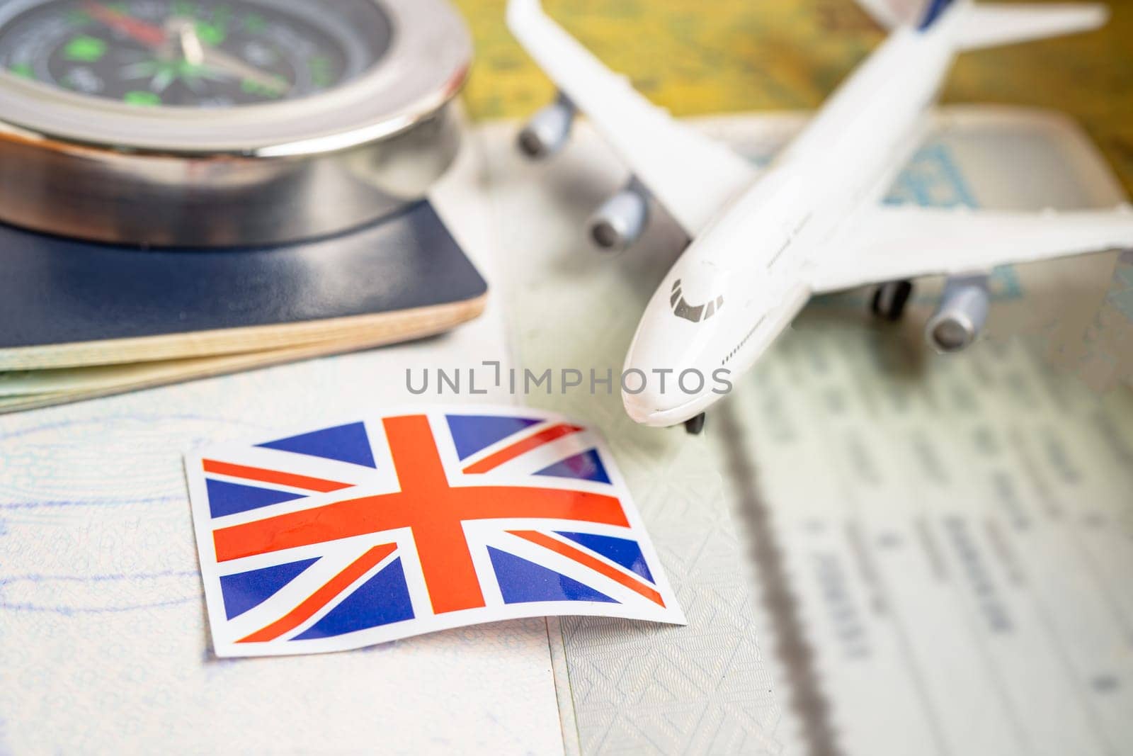 Approved Stamp visa and passport with United Kingdom flag document to immigration at airport in country.