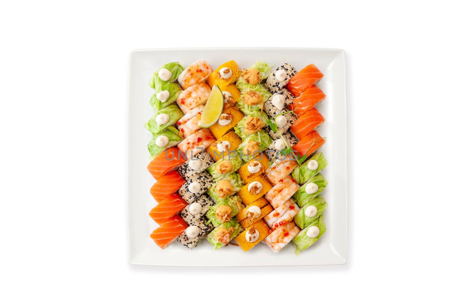 Assorted sushi big set on a white plate isolated. A variety of Japanese sushi with tuna, crab, salmon, eel and rolls. Top view. High quality photo.