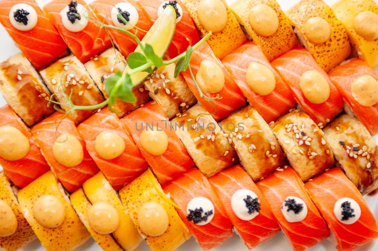 Assorted sushi big set close-up background. A variety of Japanese sushi with tuna, crab, salmon, eel and rolls. Top view. High quality photo