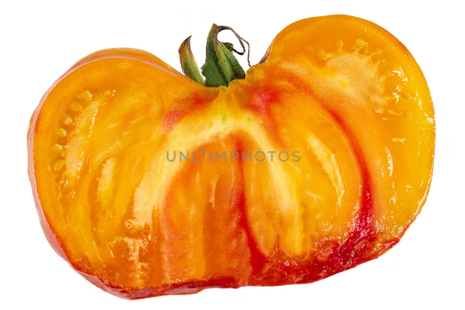 Studio shot of half yellow and orange tomatoes on white background