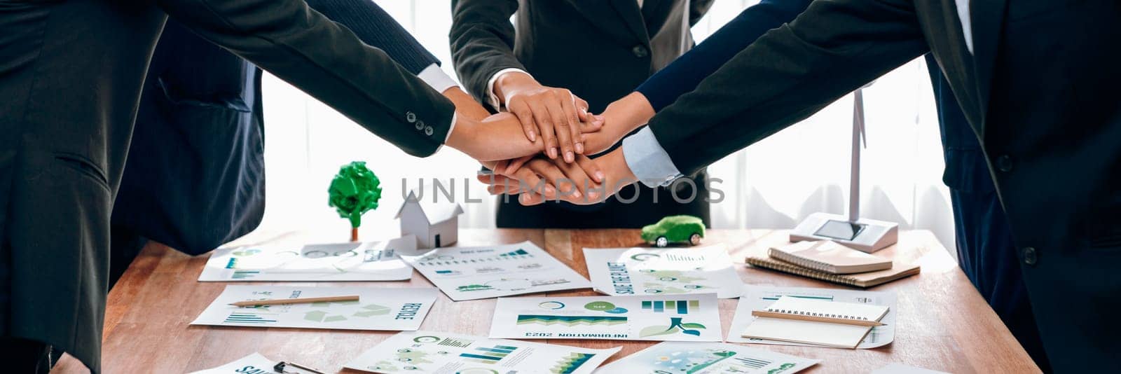 Group of business people put hand stack showing eco synergy. Trailblazing by biancoblue