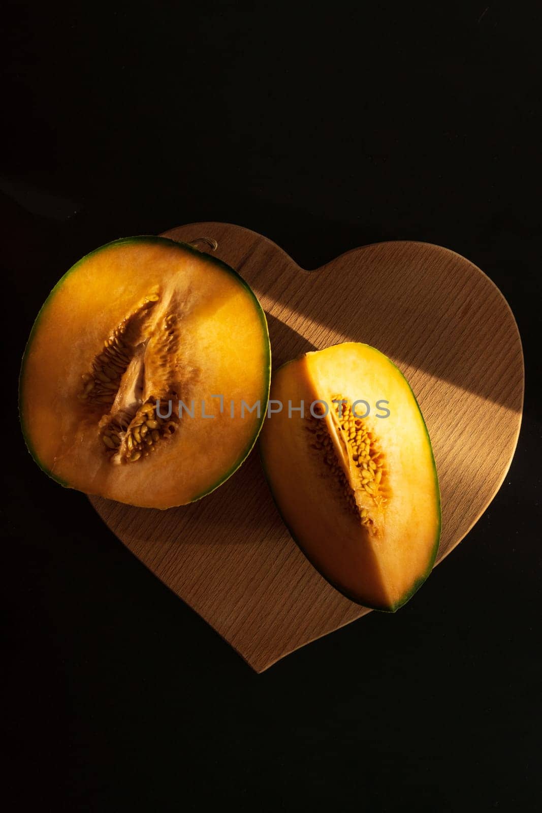 Cut yellow slices of ripe melon, close-up. A sweet delicious natural. Vertical photo