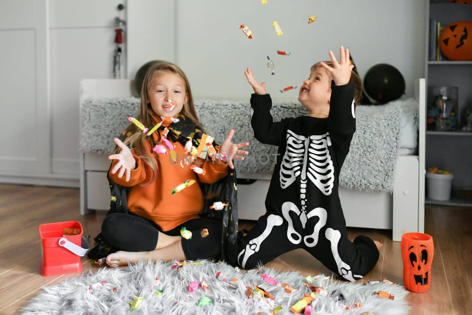 Children enjoy candy collected for Halloween by Godi