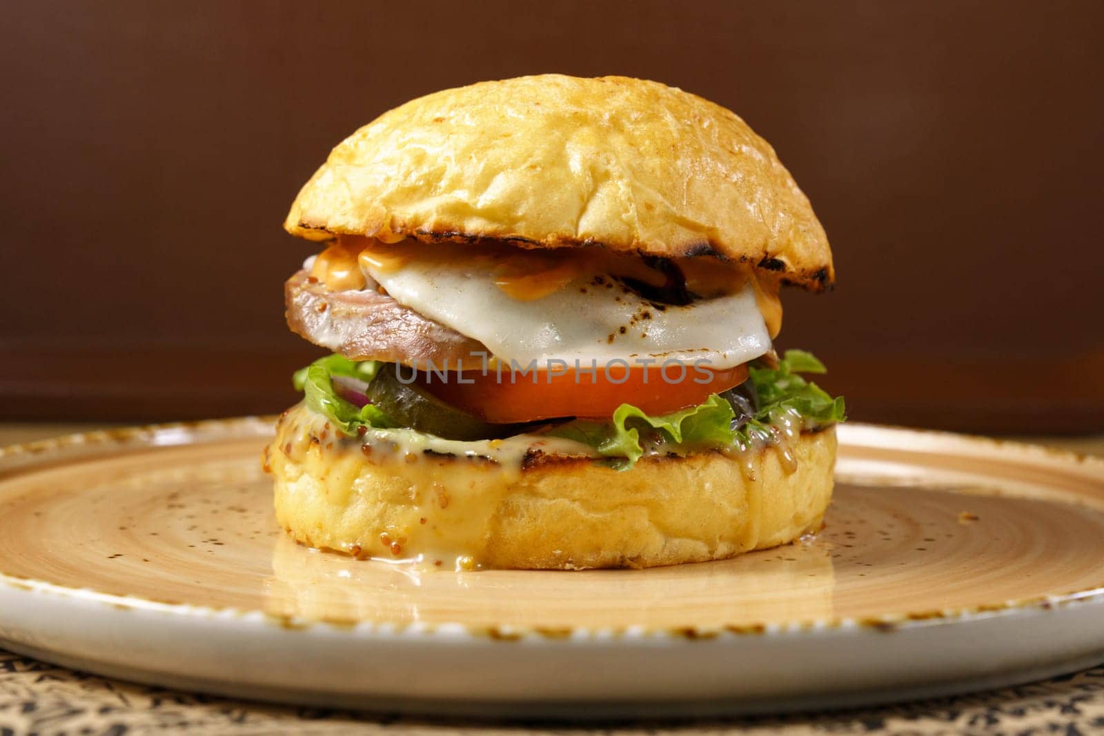 Burger with beef tongue, cheese salad and tomato close-up. Selective focus by darksoul72