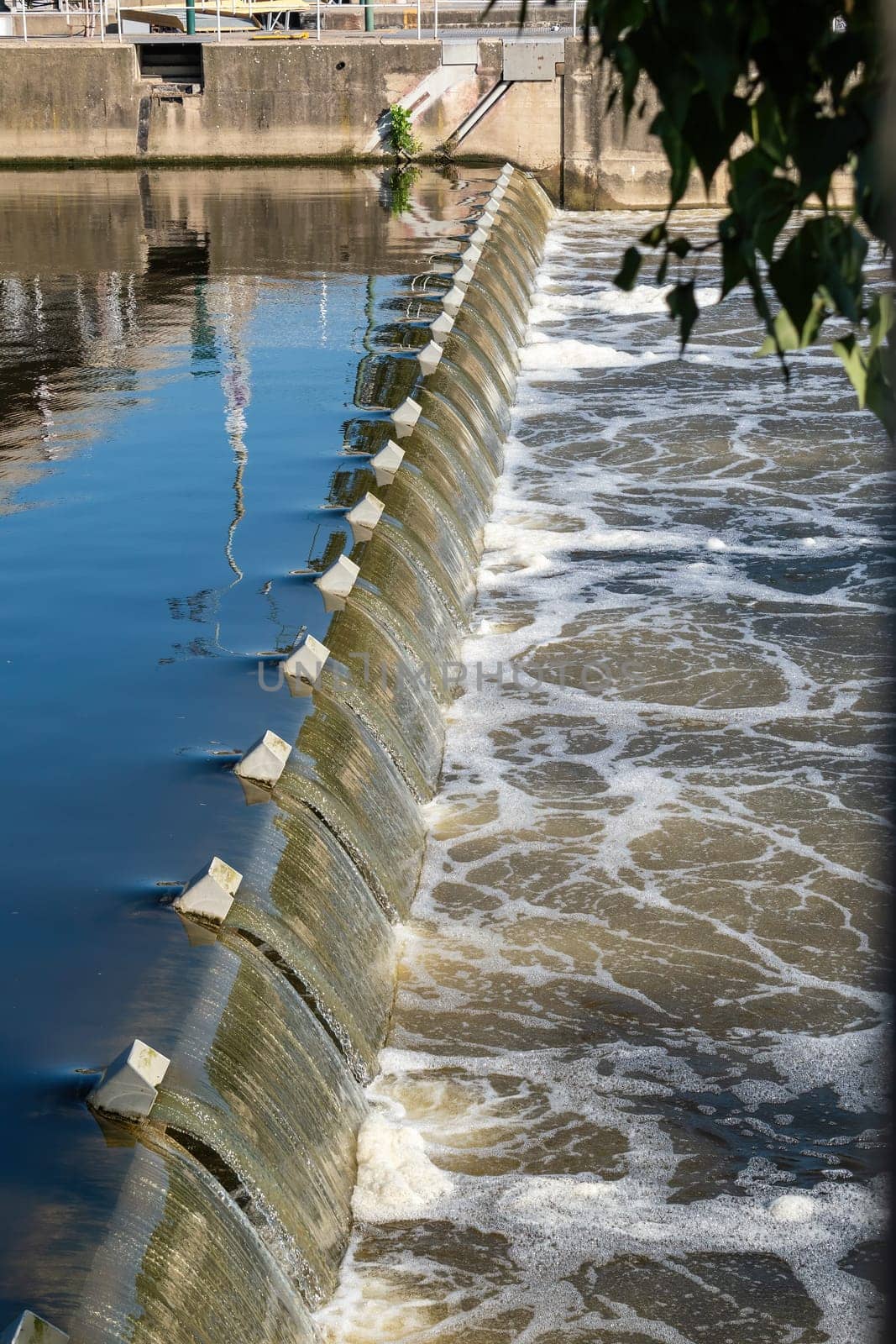 Weir under the Hlavka Bridge in Prague, water overflowing over the weir