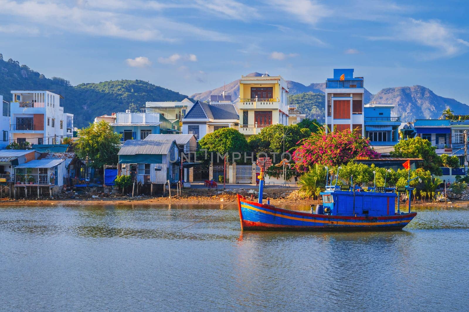 There are many traditional Vietnamese fishing boats and vessels in the bay on the river at Vinh Truong Fishing Port in Nha Trang, Vietnam