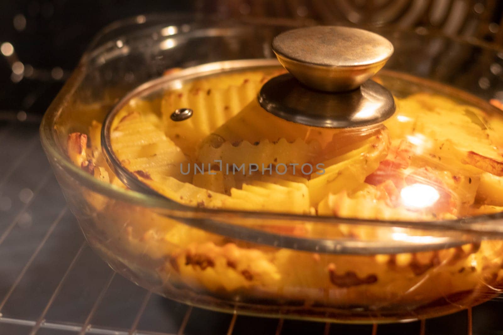 Vegetables baking in the transparent dish in the oven.