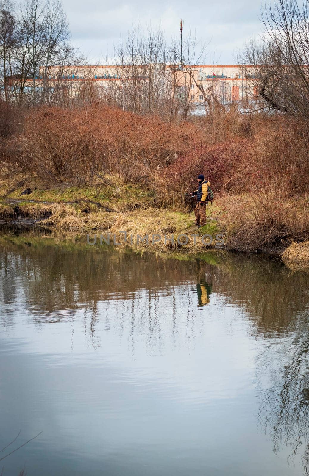 Shot of the man fishing on the winter river