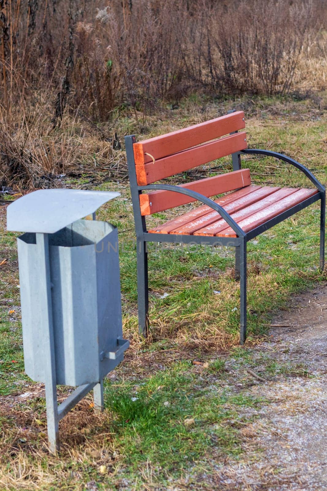 Shot of the trash bin by the bench in the park