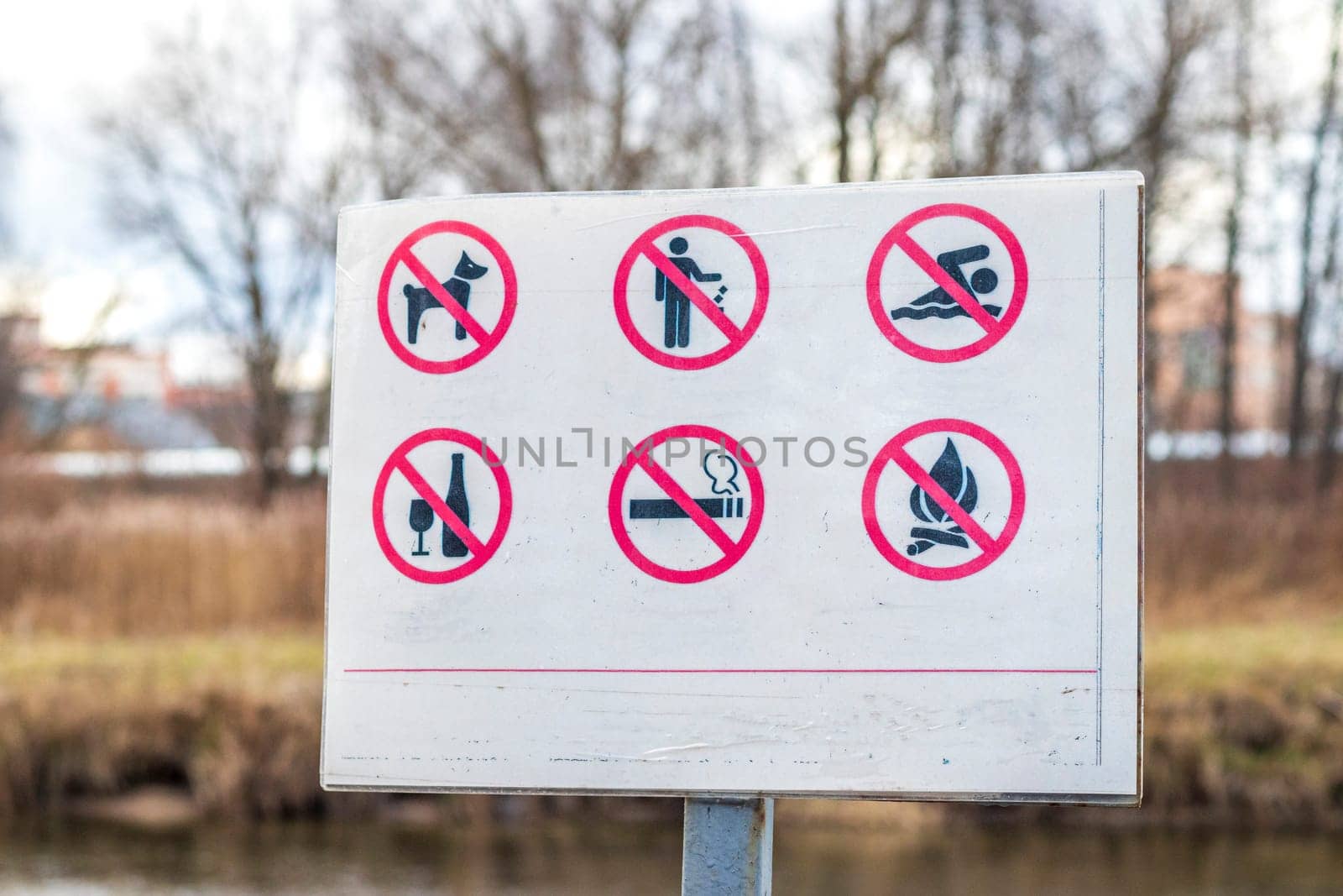 Close up shot of the information board in the park with restriction icons