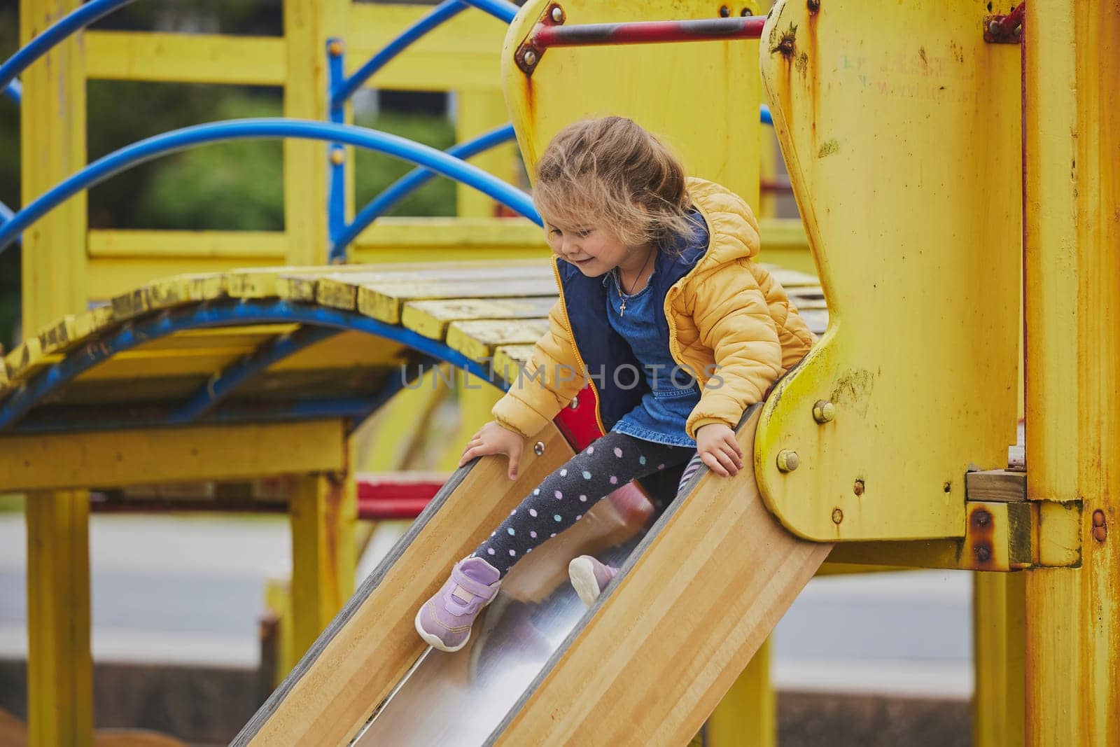 Charming child playing on a playground in Ringkobing Denmark.