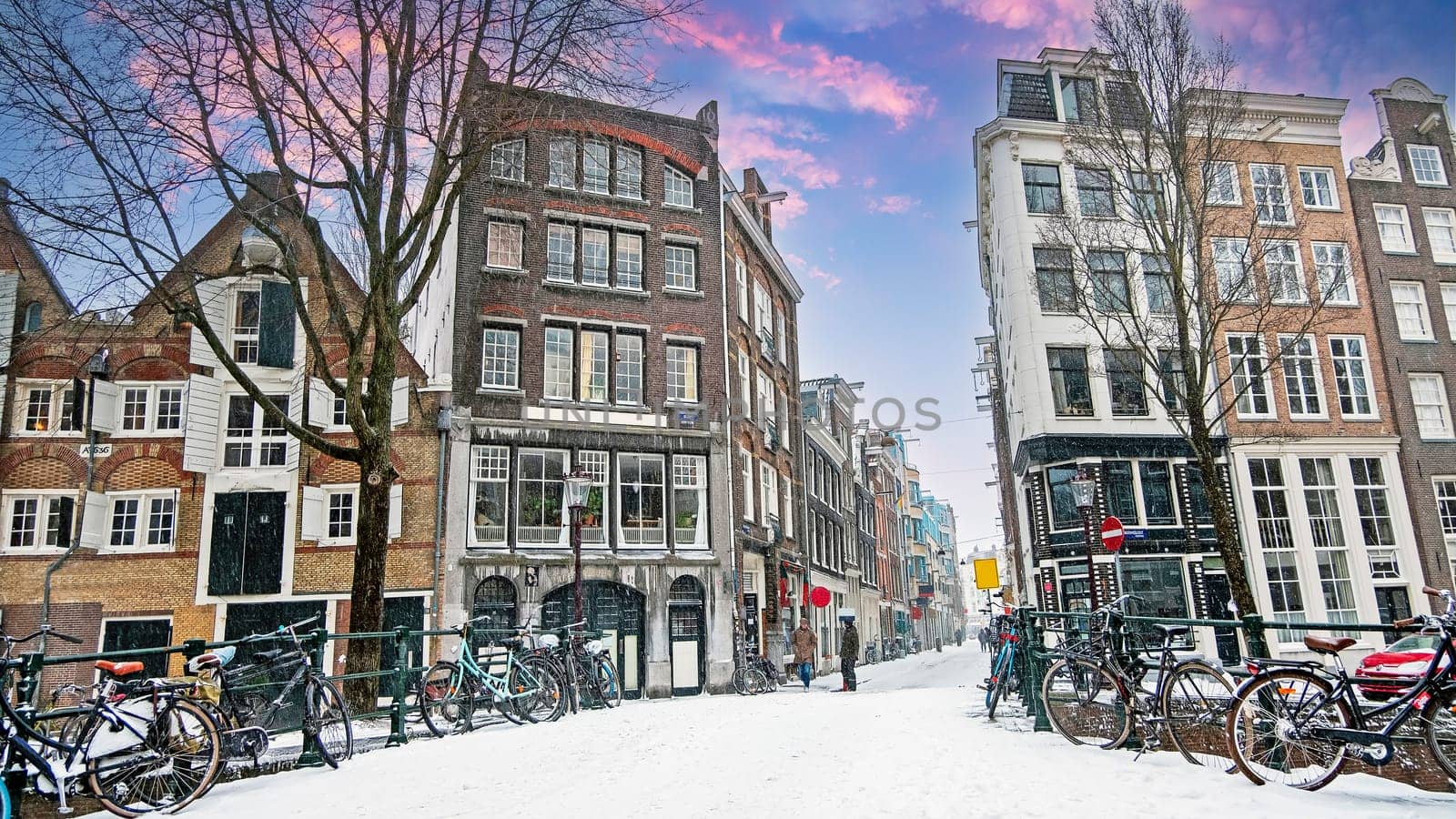 Snowy city Amsterdam in the Netherlands with the St. Nicolas church in winter