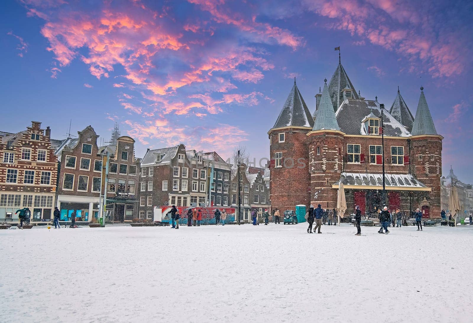 View on historical De Waag in Amsterdam in winter at sunset in the Netherlands