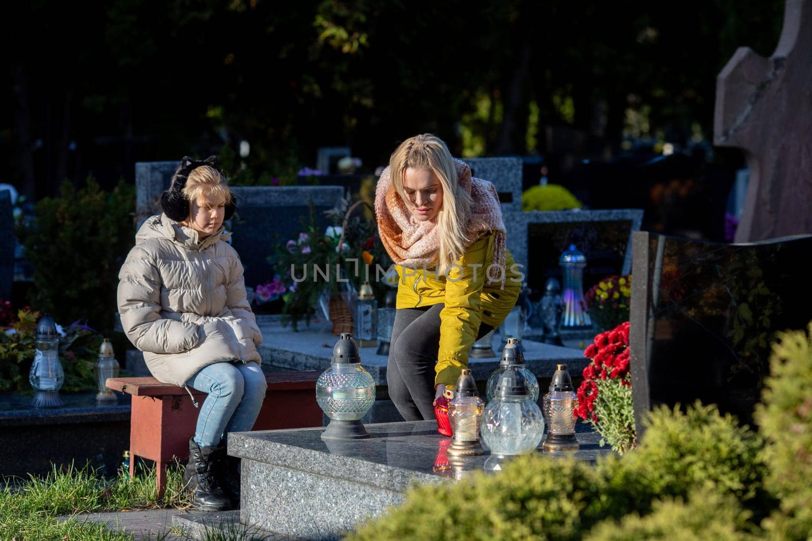 Women gathered together to pay homage at a grave, symbolizing their love, remembrance, and deep connection