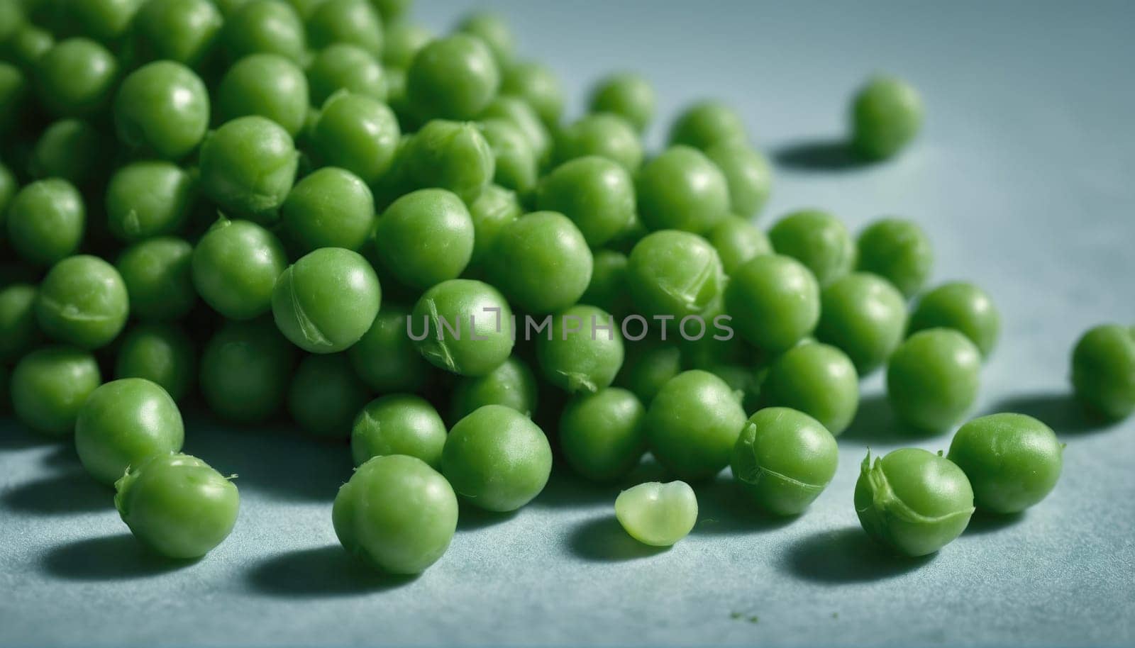A large quantity of vibrant green peas is spread across a textured surface, showcasing their natural color. These fresh vegetables are ideal for various dishes.