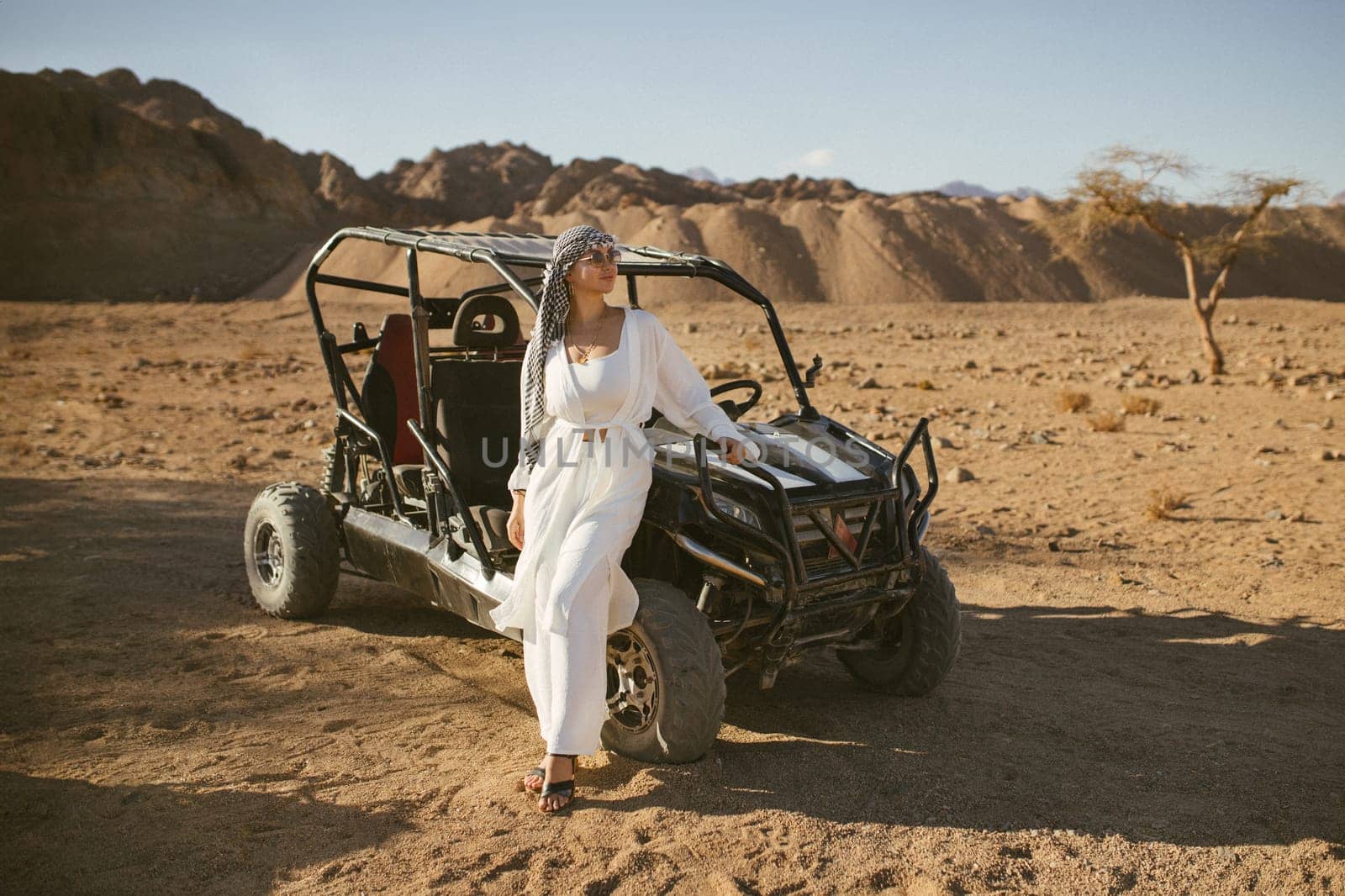 Woman tourist on quad bike ATV safari with desert background of Sharm El Sheikh Egypt.