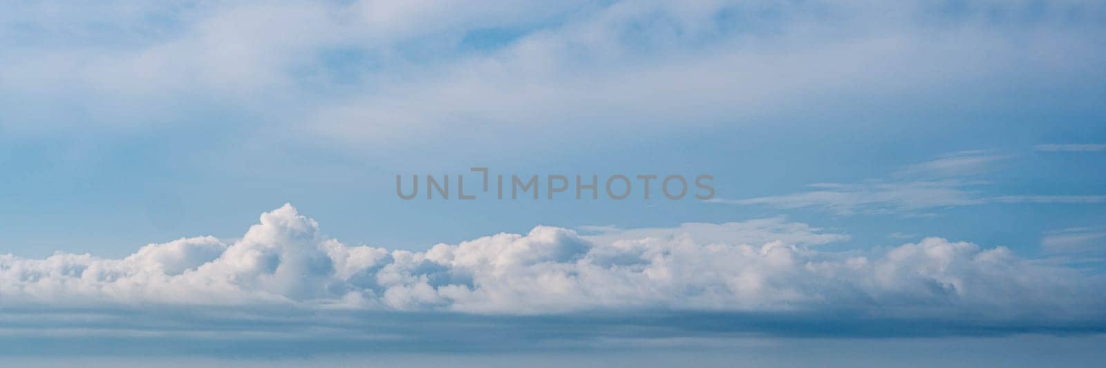 BANNER Atmosphere long panorama real photo beautiful summer white cloud clear blue sky line calm. Concept paradise life. Design relax wallpaper background More tone format fantasy collection in stock