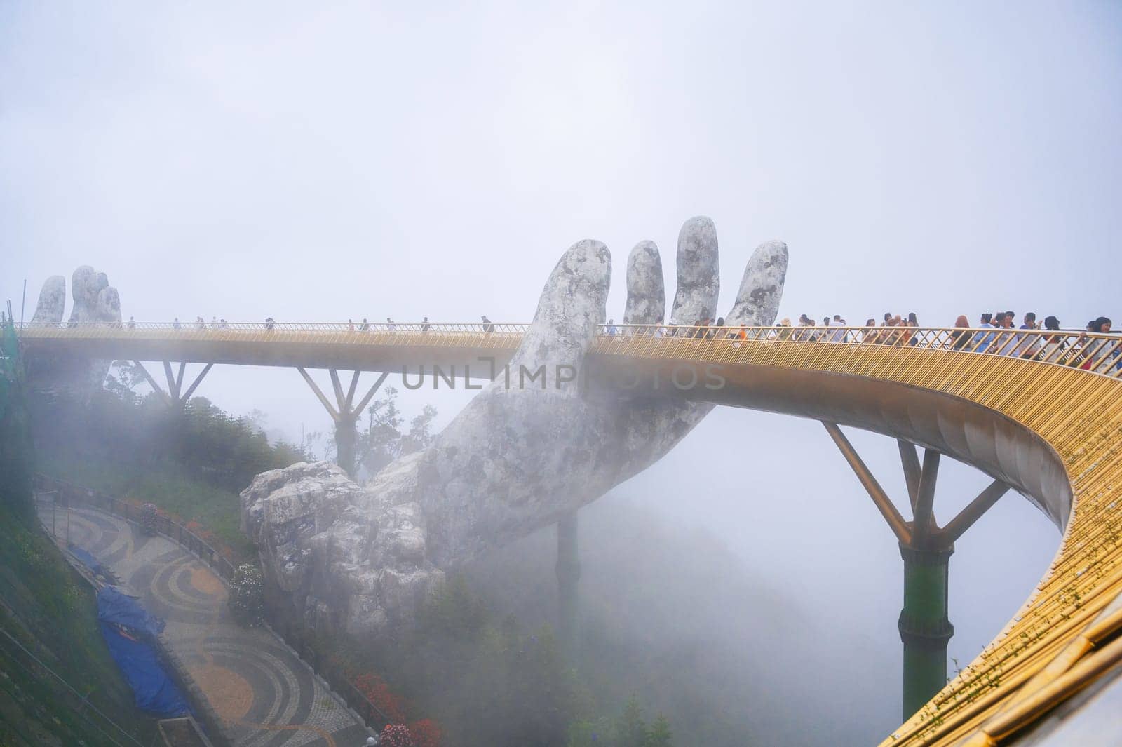 Golden Bridge or Hands of God in Ba Na Hills Park in Da Nang on the mountain in the fog. Da Nang, Vietnam - September 13, 2024