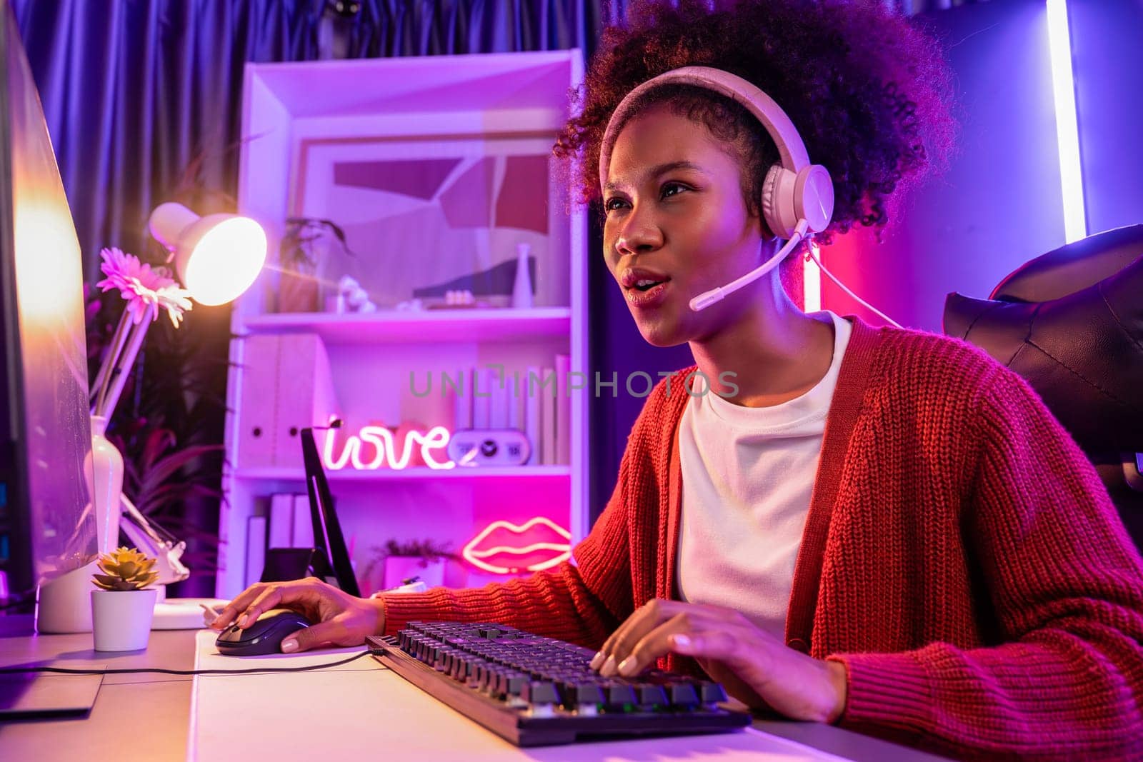 Host channel of gaming streamer, African girl wining with Esport skilled team player and viewers online game in neon color lighting room. Concept of cybersport indoor activities. Tastemaker.