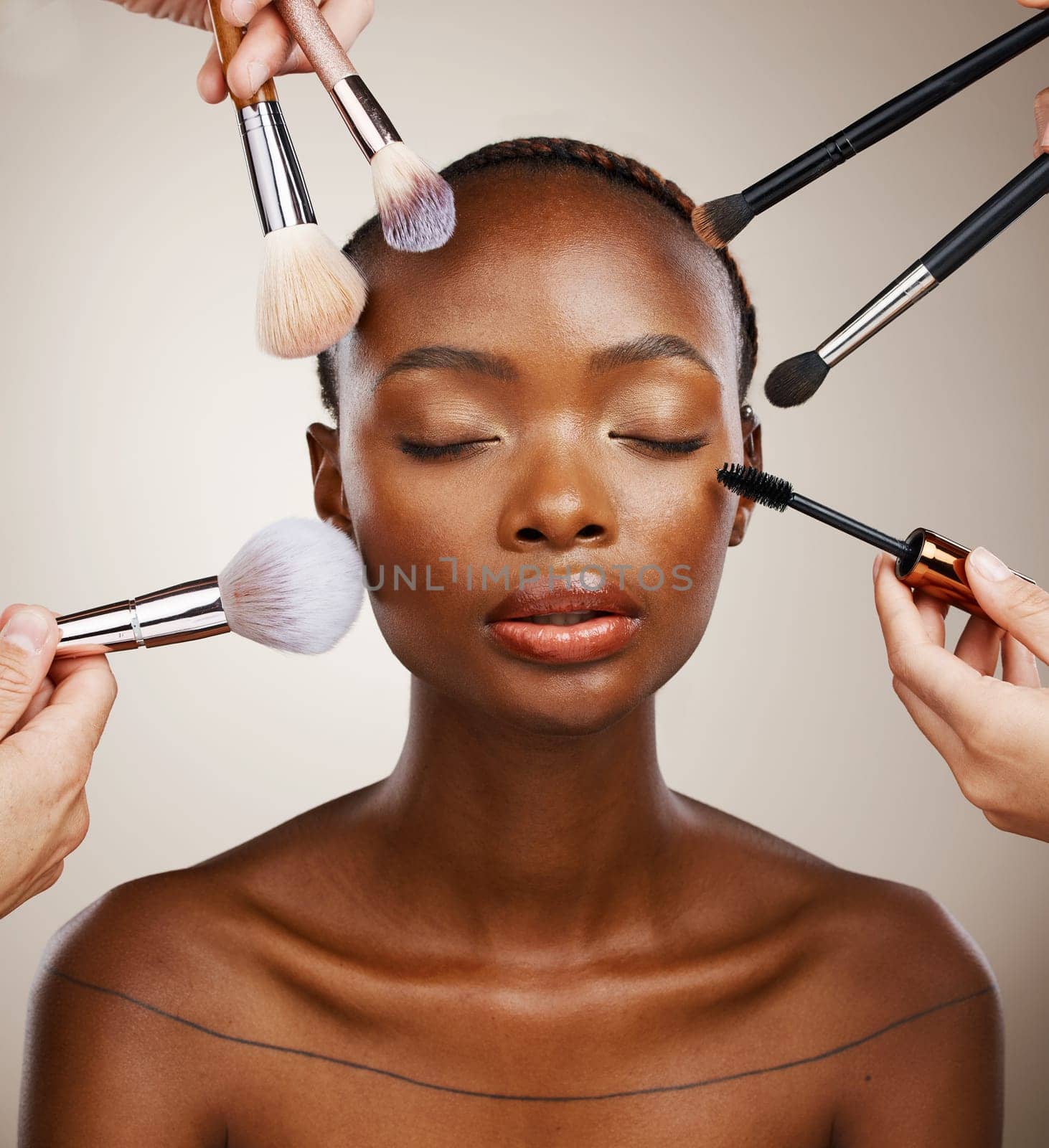 Makeup, brushes and black woman with cosmetics, skincare and dermatology on grey studio background. African person, wellness or model with tools, grooming and treatment with luxury or shine with glow.