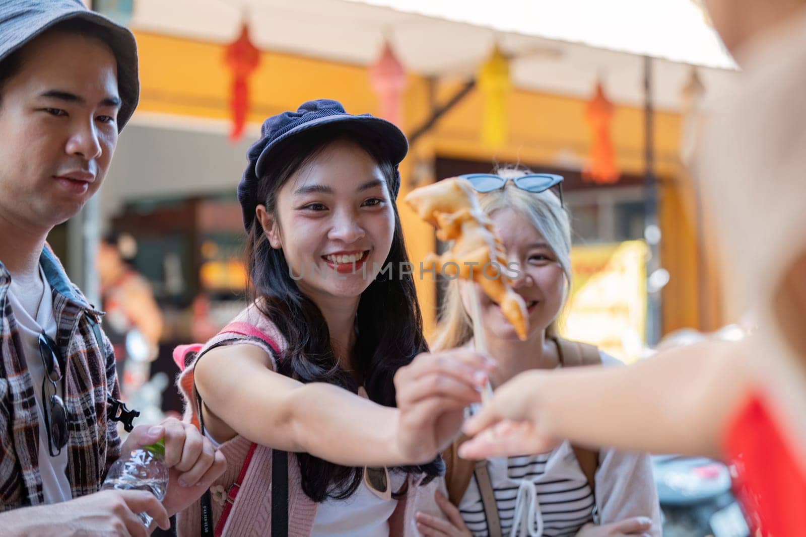 Friends share joyful moments delicious street food together.