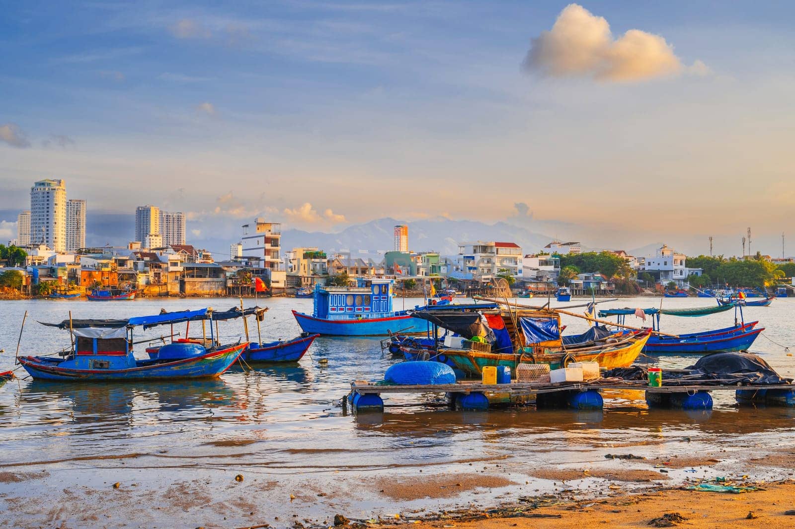 Traditional Vietnamese fishing boats, ships and vessels at the fishing seaport Vinh Truong on the sea in Nha Trang in Vietnam.