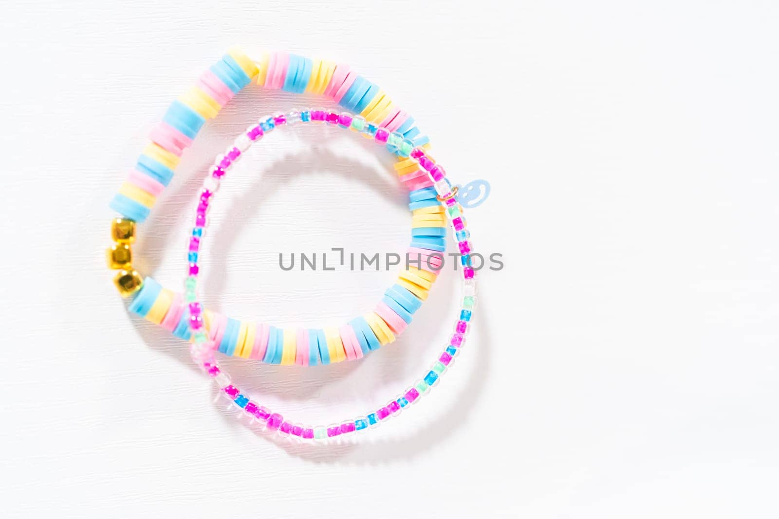 Little girl's charming bracelets adorned with clay and sea beads.