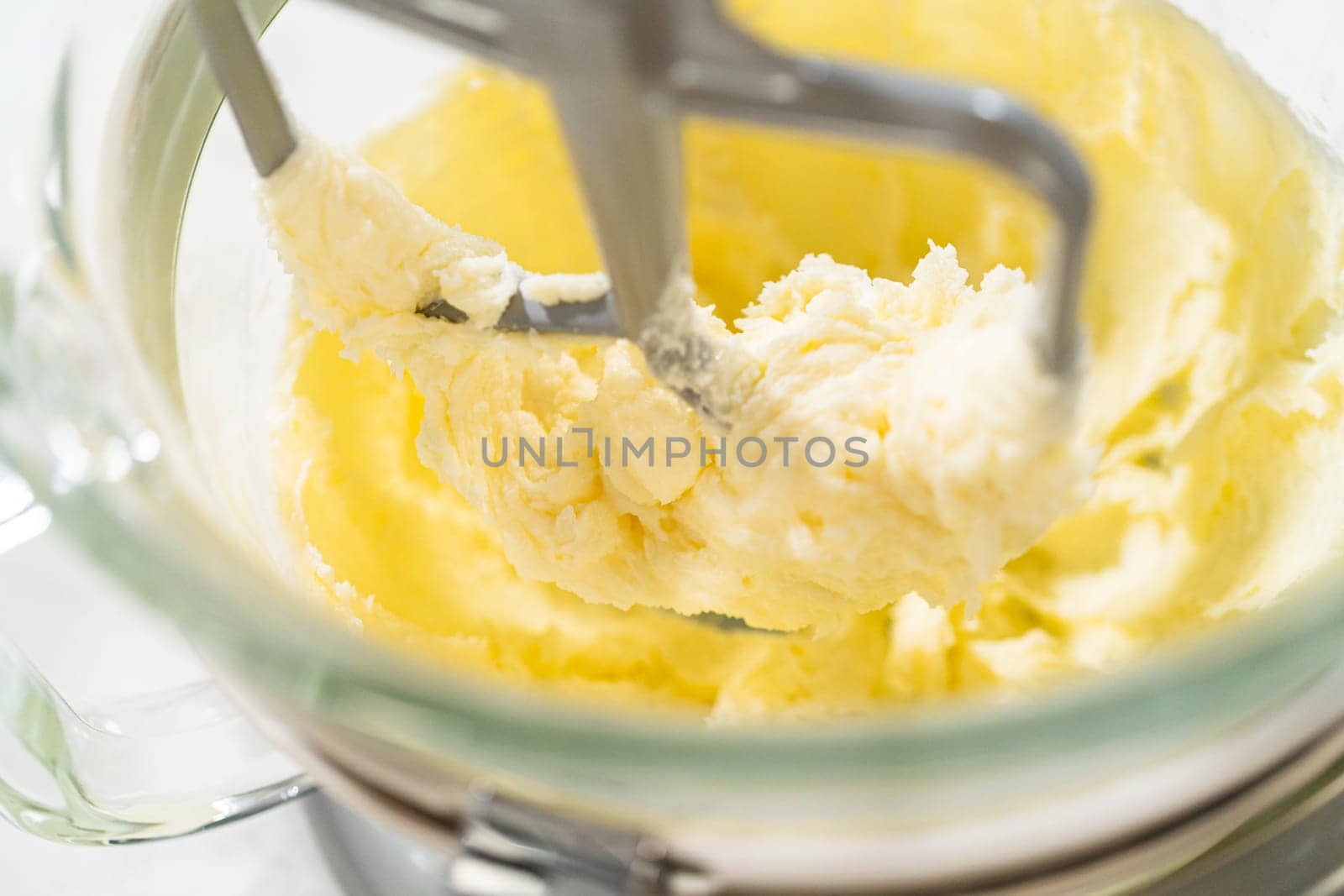 Close-up of a stand mixer creaming together butter and sugar for the Chocolate Ginger Sugar Cookie Dough, creating a light, fluffy base.