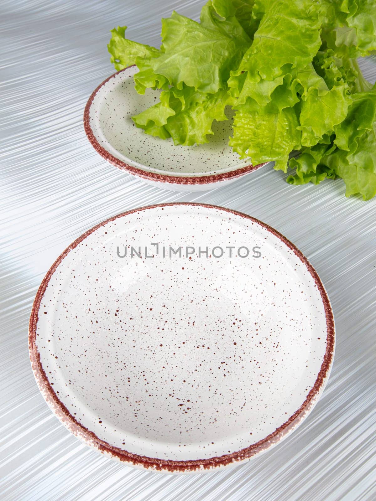 Ceramic clay plate with dark edging on gray background