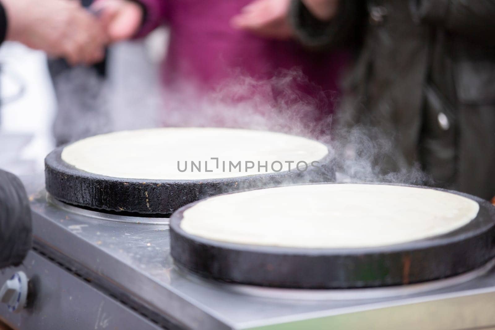 Street food. Fried pancakes in a street cafe.