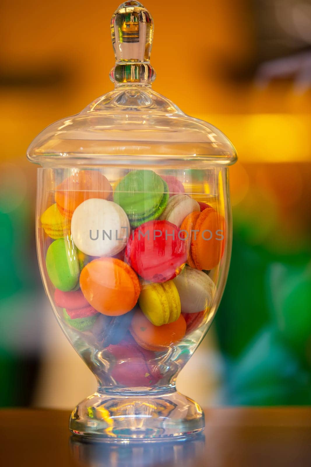 Glass vase with multi-colored marshmallow candies.