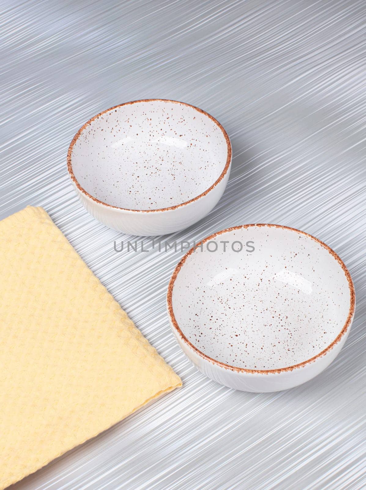 Ceramic clay plate with napkin on gray background