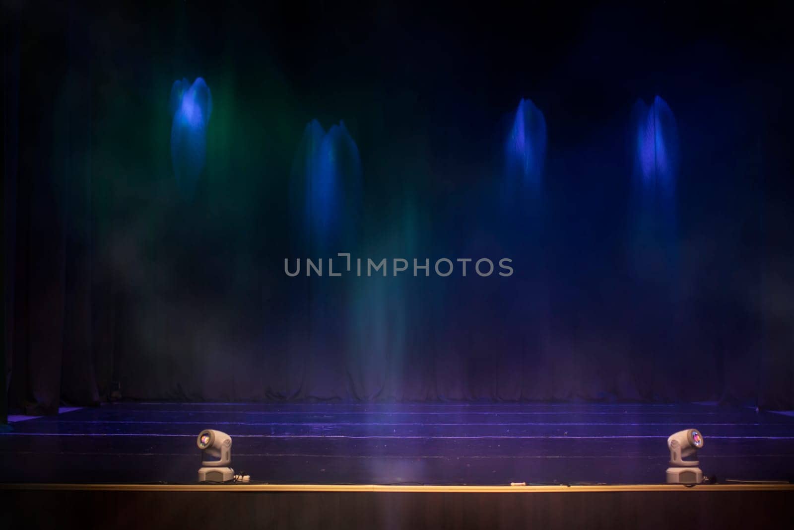 Empty retro wall background with blue rays of light and smoke.