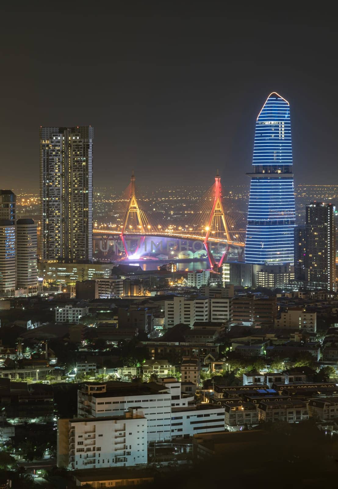 Bangkok, Thailand 31 Dec, 2024 - Nightscape view after sunset of Skyscrapers in the business district and Bhumibol Bridge. Beautiful city of Bangkok with bright glowing lights in the sundown, use it as your Wallpaper, Poster and Space for text, Selective focus.