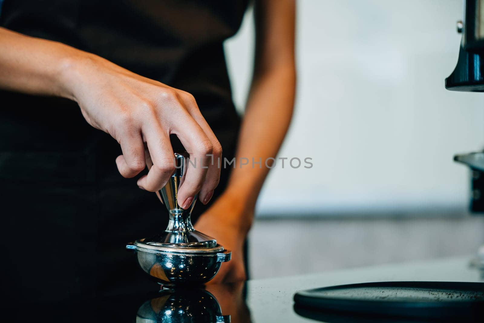 Fresh tasty coffee brewed by coffee machine in cafe or pub. Step by step guide to professional coffee making. Close up of machine hand holding handle pouring espresso.