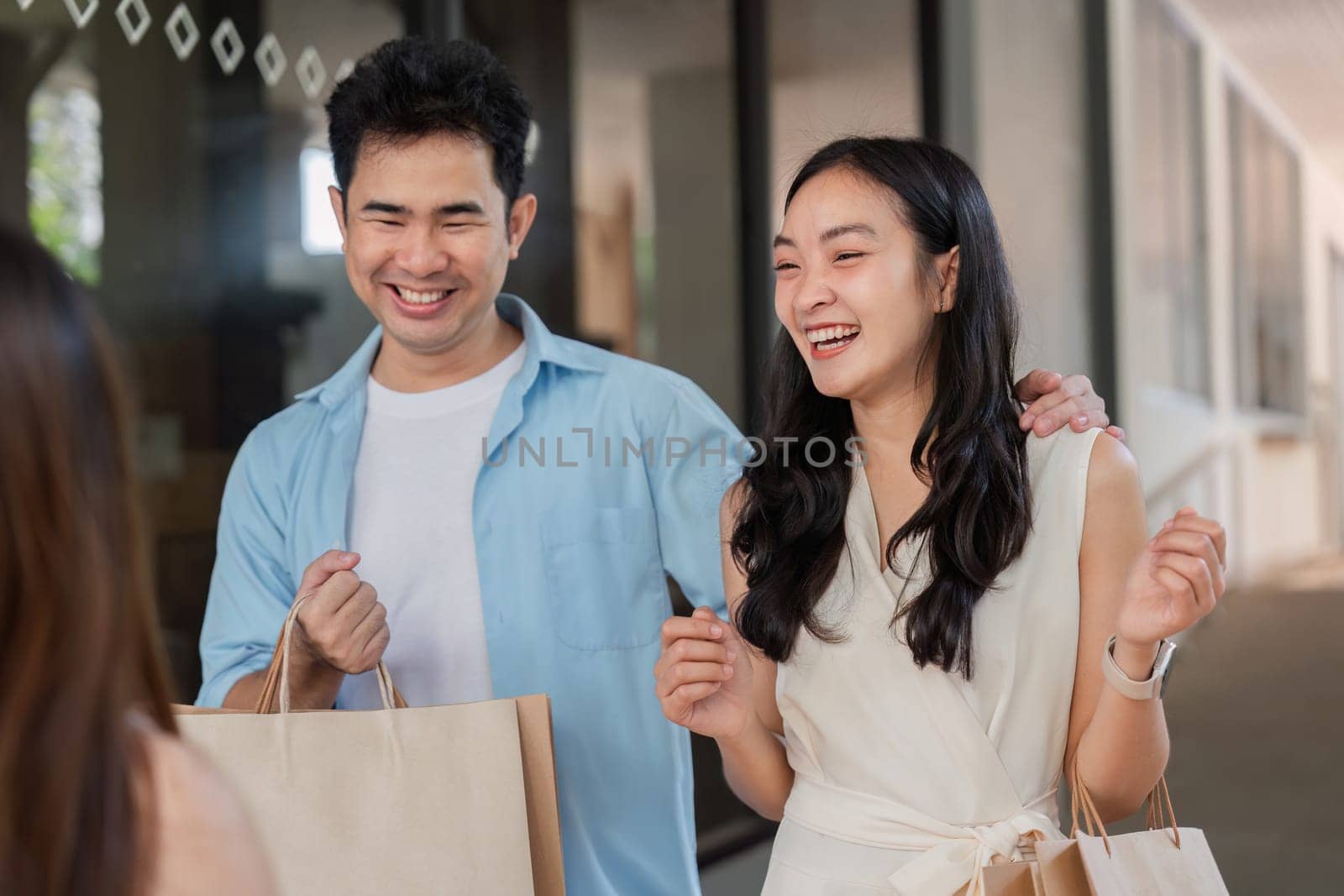 Happy parents and children enjoy a lively holiday shopping trip, sharing laughter and excitement.